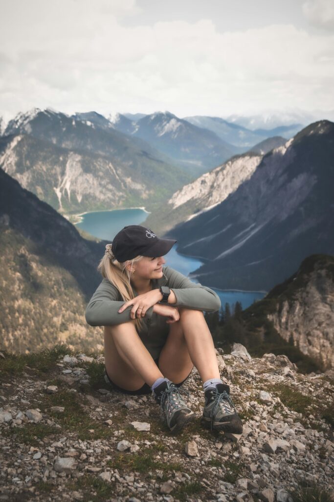 Hiker practicing nervous system regulation and body wellness in alpine terrain, photo by Oliver Dohrn