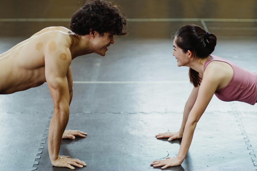 Two people holding plank facing each other during fitness wellness training, personalized workout program, photo by Ketut Subiyanto https://www.pexels.com/@ketut-subiyanto/