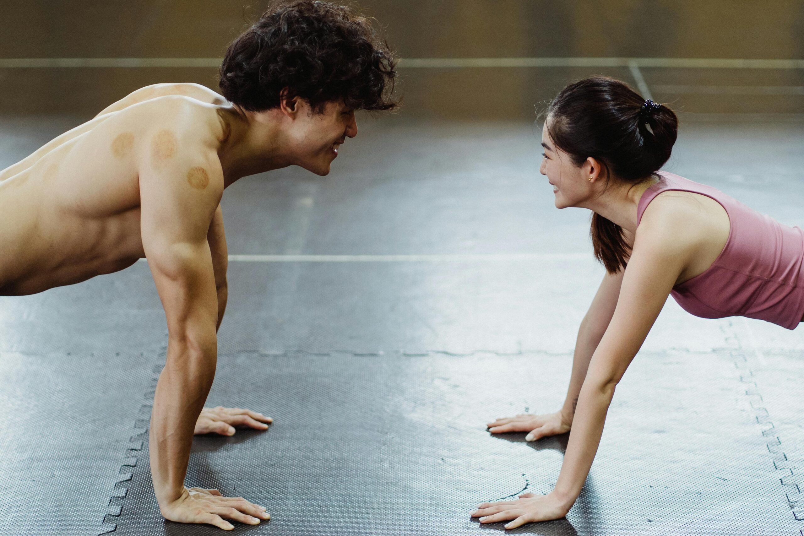 Two people holding plank facing each other during fitness wellness training, personalized workout program, photo by Ketut Subiyanto https://www.pexels.com/@ketut-subiyanto/